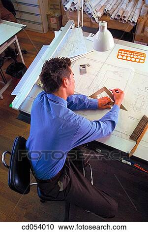 Architect working on plans View Large Photo Image Stock Image - Architect working on plans. Fotosearch