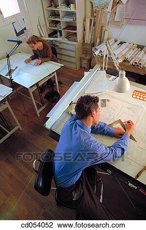 Architects working on plans View Large Photo Image Stock Image - Architects working on plans. Fotosearch