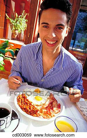Stock Photo - at-home, breakfast, black hair, bacon, activity. Fotosearch