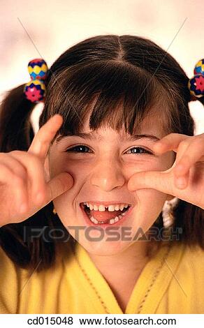 Stock Photo - Baby teeth, carefree, brunette, amusement. Fotosearch