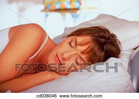 Stock Photograph - bed, brunette, at-home. Fotosearch