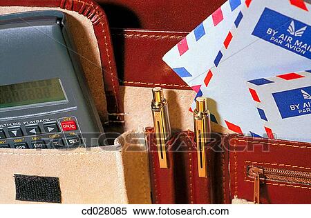Briefcase interior with calculator, pens and stationary View Large Photo Image Stock Photography - Briefcase interior with calculator, pens and stationary. Fotosearch