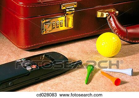 Stock Image - Briefcase, mobile phone, golf ball and tees. Fotosearch