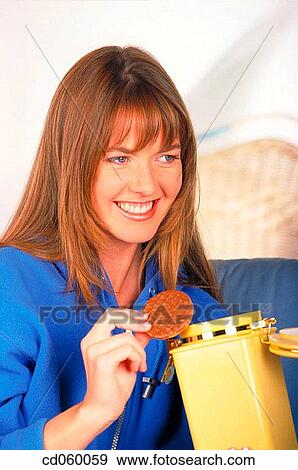 Stock Photo - brunette, Chocolate cookie, cookie. Fotosearch