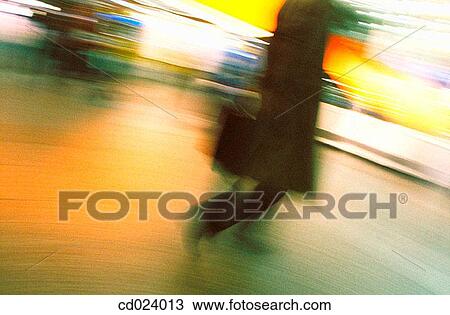 Stock Image - business, activity, briefcase, blurred motion, airport, action. Fotosearch