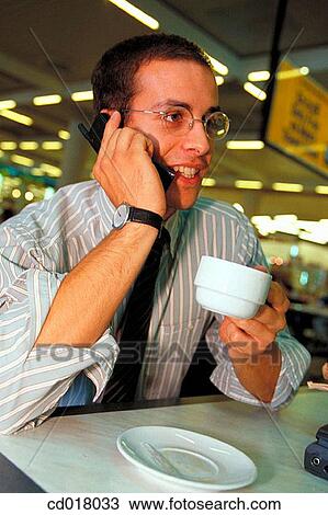 Stock Image - business, businessman, businesspeople, cafe, calling. Fotosearch