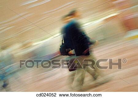 Stock Image - businessman, activity, business, blurred motion, airport, action. Fotosearch