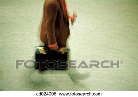 Stock Photograph - businessman, activity, business, briefcase, blurred motion, action. Fotosearch