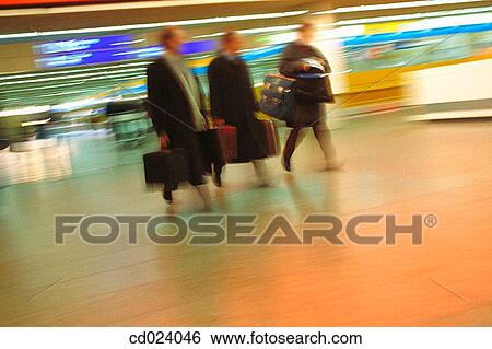 Stock Photograph - businessman, activity, business, blurred motion, airport, action. Fotosearch
