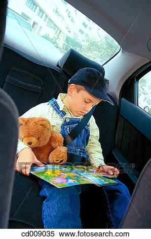 Stock Photography - child, book, car, cap, boy, automobile. Fotosearch