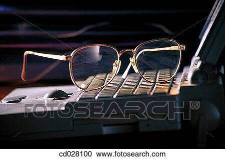 Eyeglasses on laptop computer View Large Photo Image Stock Image - Eyeglasses on laptop computer. Fotosearch