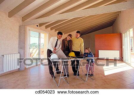 Family looking at blueprint of their new house View Large Photo Image Stock Image - Family looking at blueprint of their new house. Fotosearch