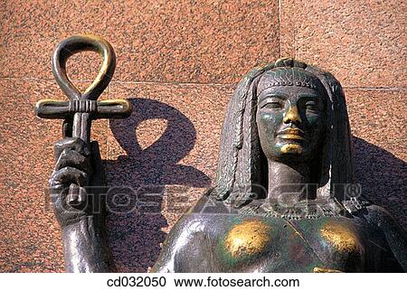 Female statue holding an ankh or ansate cross, an ancient hyerogliph signifying life". Alexandria" View Large Photo Image Stock Image - Female statue holding an ankh or ansate cross, an ancient hyerogliph signifying life". Alexandria". Fotosearch