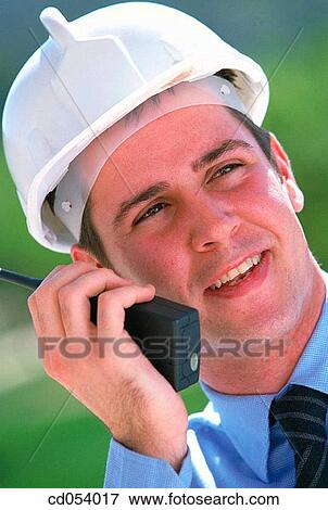 Stock Photo - Foreman giving orders by walkie-talkie. Fotosearch