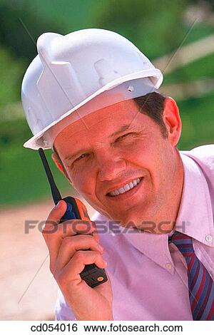Foreman giving orders by walkie-talkie View Large Photo Image Stock Photograph - Foreman giving orders by walkie-talkie. Fotosearch