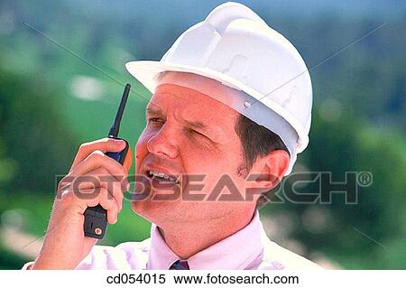 Foreman giving orders by walkie-talkie View Large Photo Image Stock Photography - Foreman giving orders by walkie-talkie. Fotosearch