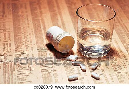 Headache tablets on stock market report View Large Photo Image Stock Photo - Headache tablets on stock market report. Fotosearch
