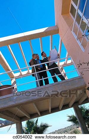 Real estate. Couple and contractor View Large Photo Image Stock Image - Real estate. Couple and contractor. Fotosearch
