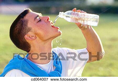 adolescence, boy, bottle, action View Large Photo Image Stock Photo - adolescence, boy, bottle, action. Fotosearch