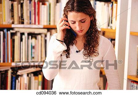 adolescence, calling, brunette, bookcase, activity View Large Photo Image Stock Photograph - adolescence, calling, brunette, bookcase, activity. Fotosearch