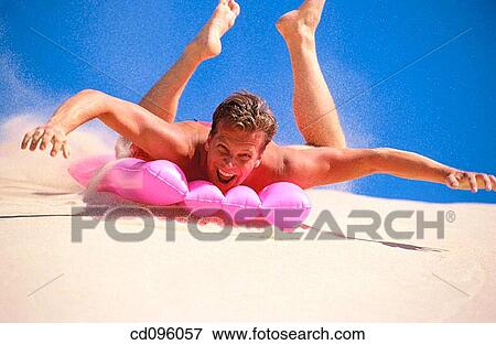 Stock Photo - air-bed, carefree, Arms open, amusement, air mattress. Fotosearch