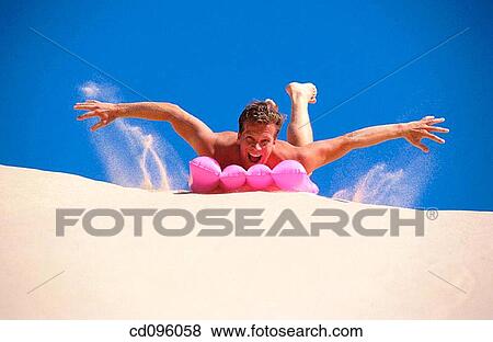 Stock Photo - air-bed, carefree, Arms open, amusement, air mattress. Fotosearch