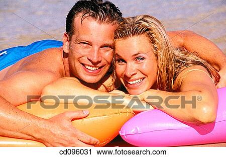 Stock Image - air mattress, Arms crossed, amusement, air-bed, affection. Fotosearch