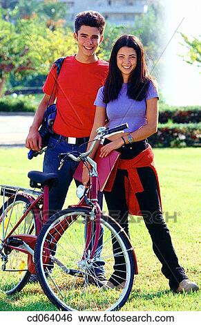 Stock Photograph - backpack, black hair, bicycle, Best friend, adolescence. Fotosearch