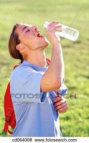 Stock Photo - backpack, carefree, boy, bottle, action. Fotosearch
