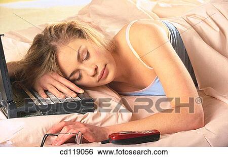 Stock Photograph - bedroom, cell phone, blond, at-home. Fotosearch