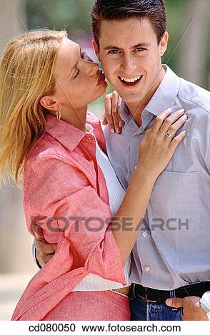 Stock Image - Best friend, bond, blond, black hair, affection. Fotosearch