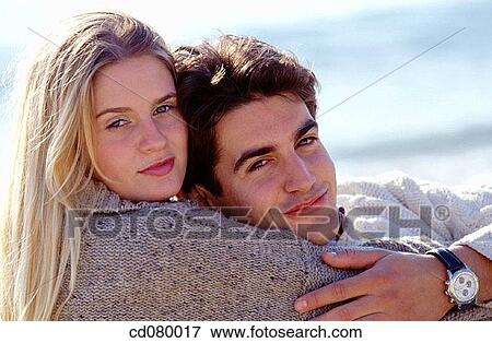Stock Photo - Best friend, bond, blond, black hair, affection. Fotosearch