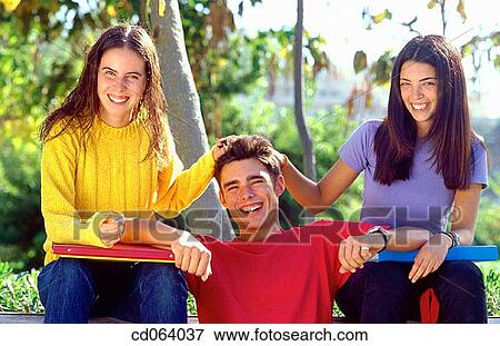 Stock Photo - boy, adolescence, black hair, Best friend, amusement, action. Fotosearch