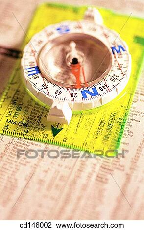 Compass on stock report View Large Photo Image Stock Image - Compass on stock report. Fotosearch