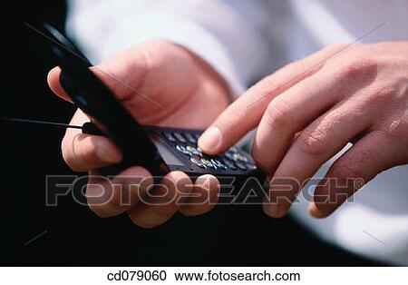 Stock Image - Hands and cell phones. Fotosearch