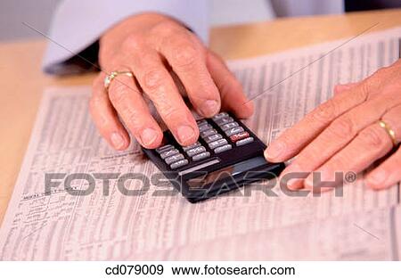 Hands, calculator and financial newspaper View Large Photo Image Stock Photo - Hands, calculator and financial newspaper. Fotosearch