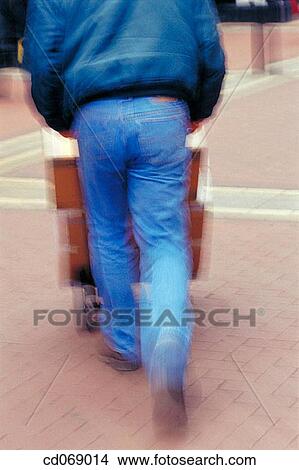 Man pushing a trolley View Large Photo Image Picture - Man pushing a trolley. Fotosearch