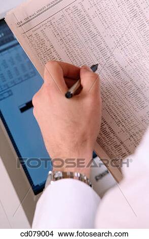 Reading financial newspaper View Large Photo Image Picture - Reading financial newspaper. Fotosearch