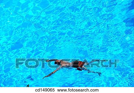 A single view of a male figure swimming in a swimming pool. View Large Photo Image Stock Photography - A single view of a male figure swimming in a swimming pool.. Fotosearch