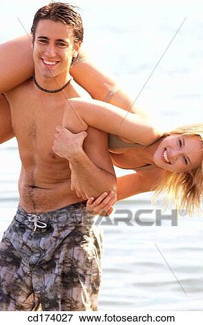 Stock Photo - amusement, Best friend, beach, bathing-suit, adolescence. Fotosearch