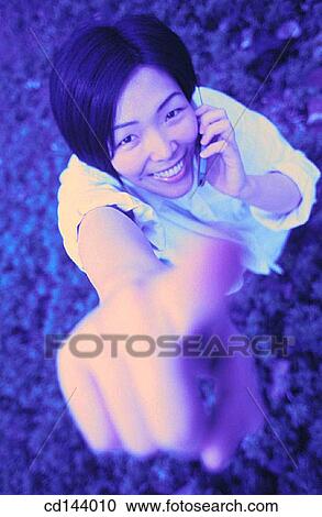 Asian-American, cell phone, carefree, calling, Asian View Large Photo Image Stock Image - Asian-American, cell phone, carefree, calling, Asian. Fotosearch