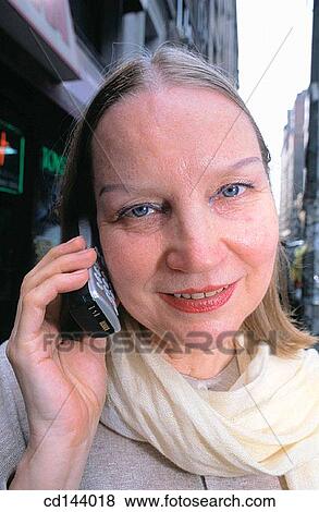 Stock Photo - baby boomer, calling, blond, absorbed. Fotosearch