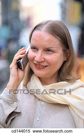 Stock Photography - baby boomer, calling, blond, absorbed. Fotosearch