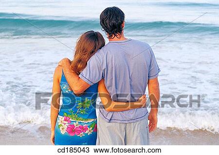 Stock Image - back view, bond, Best friend, beach, affection. Fotosearch