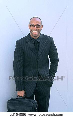 Black executive with briefcase laughing at camera View Large Photo Image Stock Photograph - Black executive with briefcase laughing at camera. Fotosearch