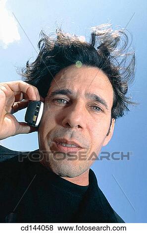 Stock Photo - black hair, calling, cell phone, Close-up. Fotosearch