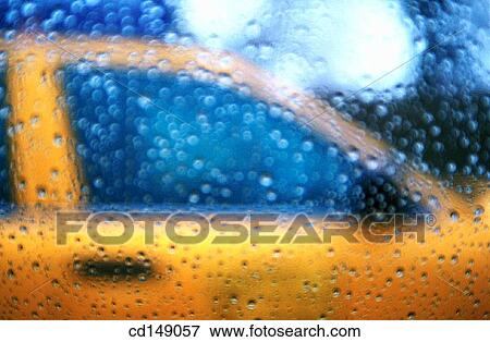 Blurry view of a New York City taxi seen through window covered in rain drops. View Large Photo Image Stock Photo - Blurry view of a New York City taxi seen through window covered in rain drops.. Fotosearch