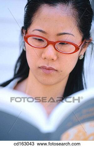 Stock Image - book, businesswoman, businesspeople, business, Asian-American. Fotosearch