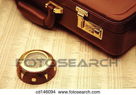 Briefcase and compass on stock report View Large Photo Image Picture - Briefcase and compass on stock report. Fotosearch