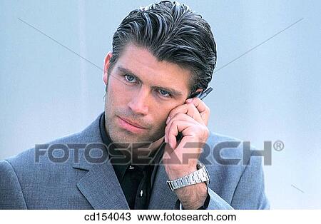 Stock Image - Businessman talking on cell phone. Fotosearch